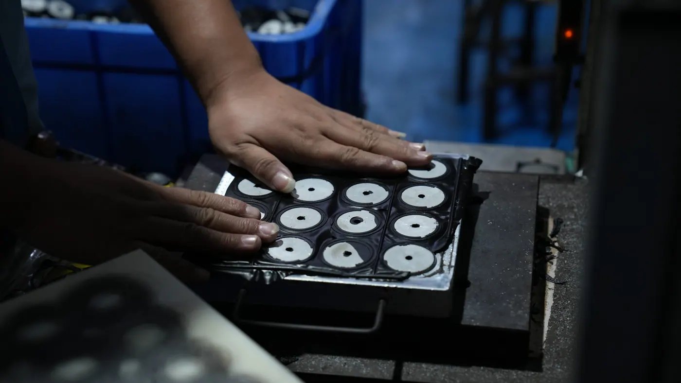 Rubber parts being removed from a mold in production